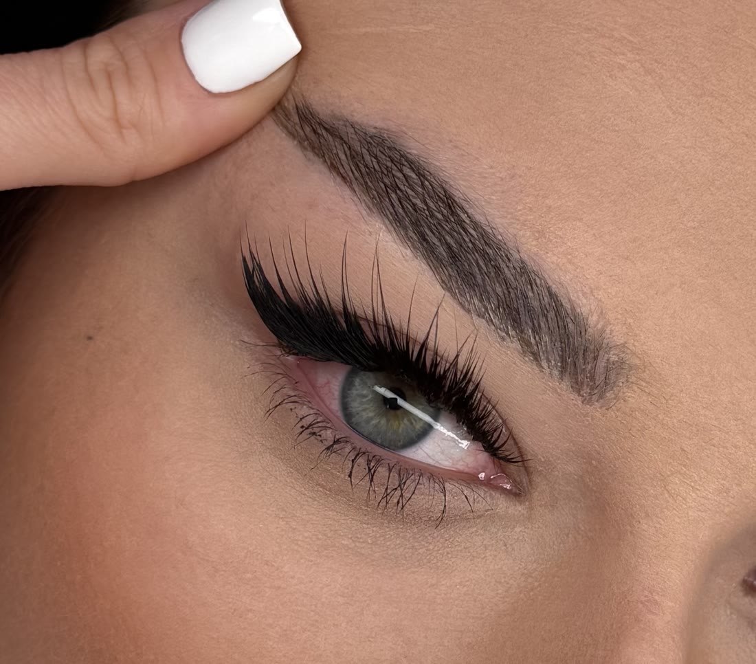 Close-up of fluffy eyelash extensions and groomed brow